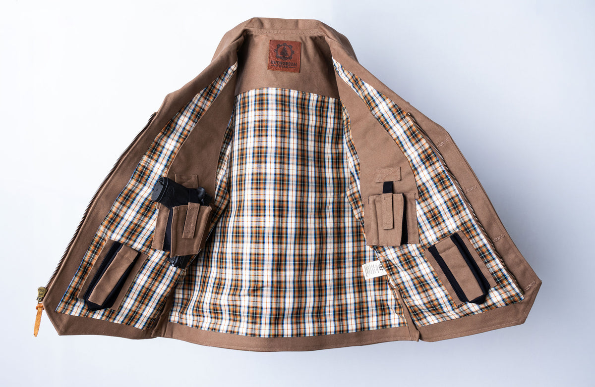 A brown utility vest shown open against a light gray background, featuring a brown and black plaid lining and multiple utility and CC pockets.